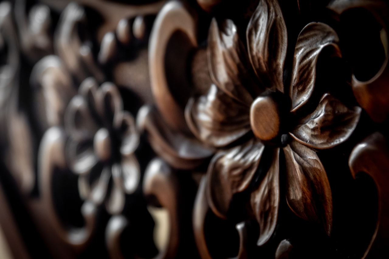 services-02 Detailed close-up of an intricately carved wooden floral pattern showcasing texture and craftsmanship.